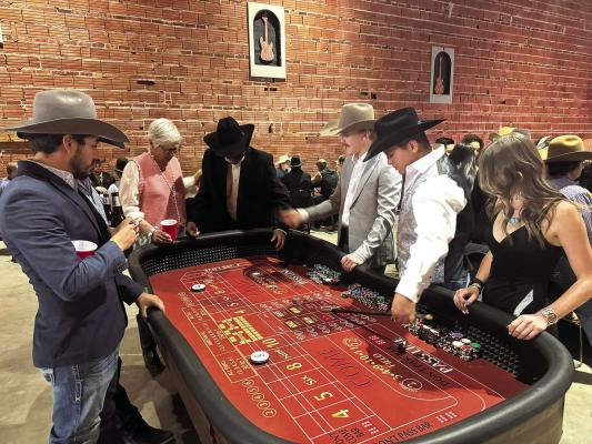 Craps shooters at the Sul Ross Rodeo Team’s Casino Night try their luck on the felt Saturday night. Proceeds from the event went to the SRSU Rodeo scholarship fund.