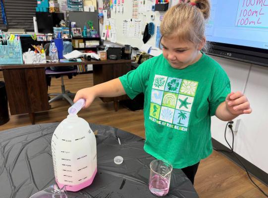 Third-grader Blakely McEntire learns about liquid volume in her math class to better understand the difference between 100, 10, and one milliliter. Courtesy photo