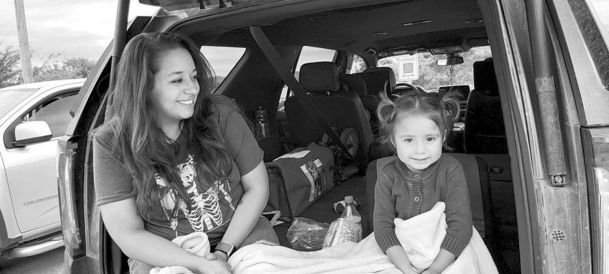 Mom Kristin Rosas and daughter Ysela Rosas, 3, of Alpine were two of the many attendees who enjoyed the festivities and colorful family friendly parade of Our Lady of Peace Catholic Church in Alpine on Oct. 8. The two-day festival was designed to bring families and friends together in a fun, faithfi lled weekend of food, live music, and entertainment. Avalanche photo by Roxanne Hill