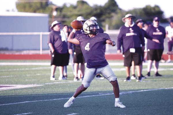 Alpine Fightin’ Buck quarterback Iden Lujan rears back to throw a pass to his receivers downfield in last Thursday’s scrimmage against the Pecos Eagles. Photo by Felipe Fierro