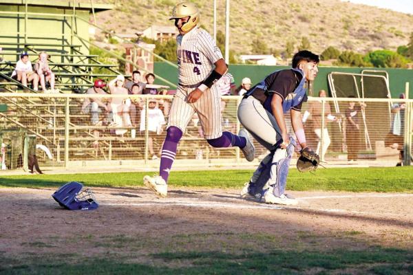 Alpine’s Josh Solis sprints across home plate as a befuddled Blue Devil’s catcher searches for the ball. Photo by Felipe Fierro