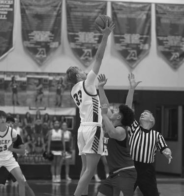Zane Wash tips the ball in the Bucks favor during the beginning of their contest against Kermit. Photo by Felipe Fierro