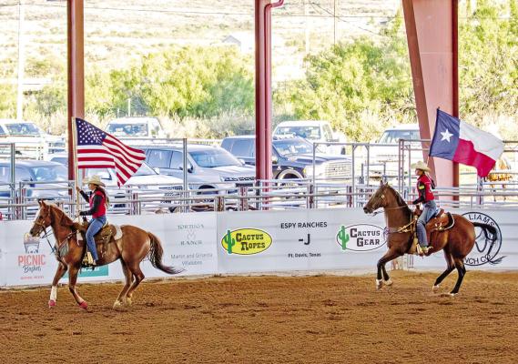 A tradition at any rodeo is honoring our American Flag. Hats come off, and hands cover hearts when Old Glory flies in the arena. Photo by Kara Gerbert