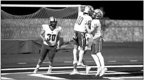 Fightin’ Buck players Iden Lujan (10), Eddie Morrison (30), and Logan Smith (11) celebrate during their away game against Tornillo last Friday. Photo by Noe Lujan