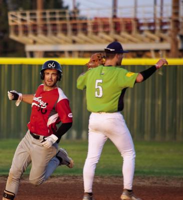 The Cowboys’ A. J. Folds clears a base against the Roswell Invaders during a game at Joe Bauman Field. Photo by Julie Myers