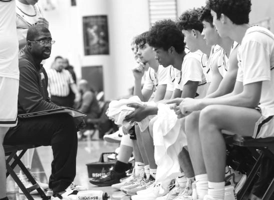The Alpine Fightin’ Bucks listen intently to Coach Hardwick as he goes over plays and strategy during a recent game. Photo by Shawn Yorks