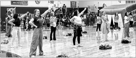 Alpine High School cheerleaders lead everyone in a decade’s celebration at last week’s pep rally. Photo by J.T. Maroney