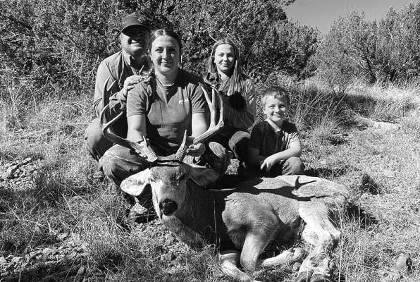 Kody Hawkins proudly exhibits her mule deer buck she harvested recently, proving that not only does she excel in school sports, but also the sport of hunting. Hawkins is pictured here with her dad T.C. Hawkins, her younger sister Kaci Hawkins, and her younger brother Trevor Hawkins.