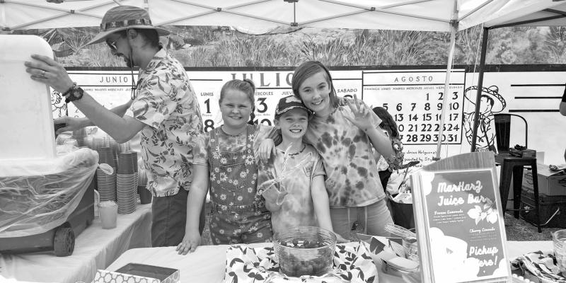 Part of the Cinco de Mayo celebration held this past Saturday included the “Downtown Hoedown” at the corner of 5th and Holland. A lemonade stand was manned by Zoe Wood, Harper Price, and Marlis Price of Alpine. Pictured in back is John Price. Photo by Kara Gerbert