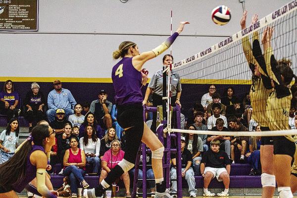 Peyton Kinkade attacks at the net against the Andrews Lady Mustangs on Tuesday night at the Buckdome. Photo by Kara Gerbert