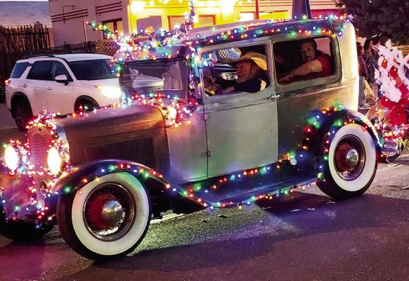 RC Toler, former owner of the Railroad Blues, dressed up his old car with festive lights for Saturday’s Christmas parade. Photo by Kara Gerbert