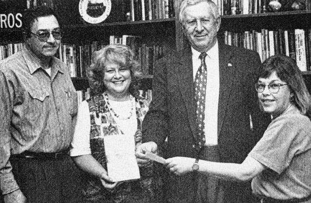 September 7, 1995 – NOTS members Robert Jensen, Leslie Lehman, and Karen Green show SRSU president Dr. Vic Morgan a $1,000 check from author Barbara Wood.