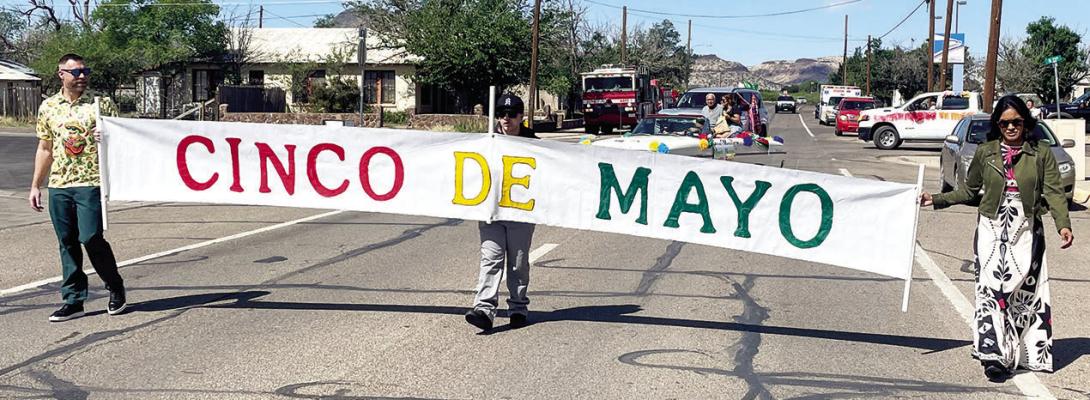 The granddaughter, her husband, and great-grandson of Manuel Natera, this year’s Cinco de Mayo grand marshal, led the parade for the holiday’s festivities. L to R are Aaron Schubert, great-grandson Michael, and Hope Schubert. Courtesy photo