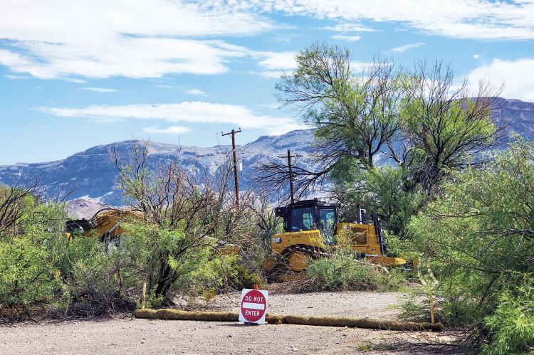 Heavy equipment rests silently on Sunday, August 16, after the border wall infrastructure began last week in Big Bend National Park. These machines were parked just past the turnoff to Cottonwood Campground, and the “new patrol road” essentially runs parallel to the already paved and maintained park road to Santa Elena Canyon. As of Sunday, the path runs from the parking lot at Santa Elena Canyon to this location. Photo by Kara Gerbert