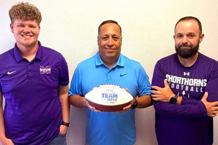 Marfa coaches Zachary Wilson, Felix Reyes, and Marcus Ortega pose with the Dave Campbell football honoring their recognition. Photo courtesy of Marfa ISD