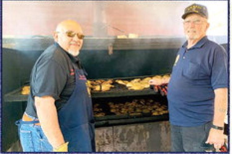 American Legion Post 79 members Andy Ramos and the late Vince LaValle cook up chicken and sausage for the Legion’s annual Independence Day barbecue in Alpine in 2019. The Legion has held its July 4th cookout for more than 100 consecutive years.