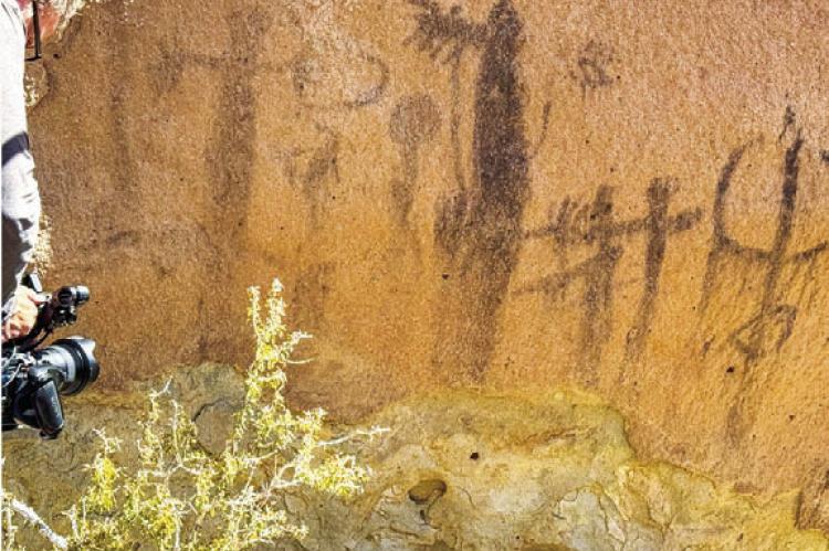 Cameraman Grant Kauffman shoots pictographs during the filming of Expedition: Tales of the Big Bend. Photo courtesy of Wild Yeti Films