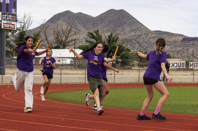 These Alpine 6th-grade girls give it everything they have in the relay race just before school ended at Buck Stadium. Courtesy photo