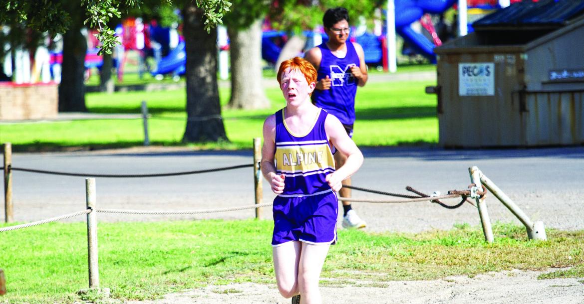 In his first cross-country meet as a new high school freshman, Ty Ritchie rounds the corner during the boys’ JV race at Pecos’ Maxey Park for the West of the Pecos race. Photo by Kara Gerbert
