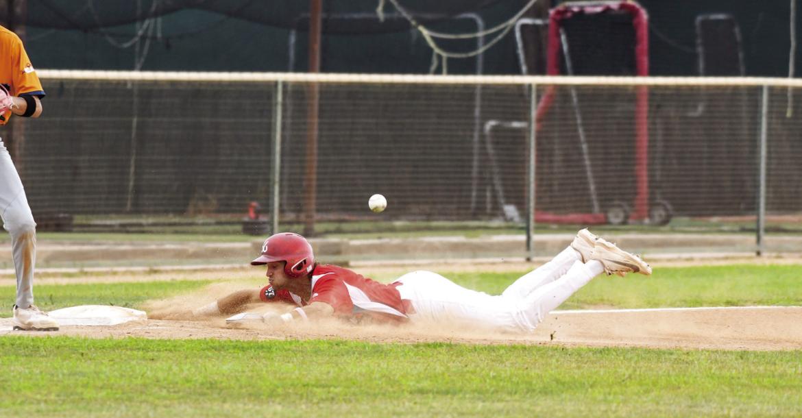 Nathan Mix slides into third to beat the tag at Kokernot Field. Photo by Julie Myers